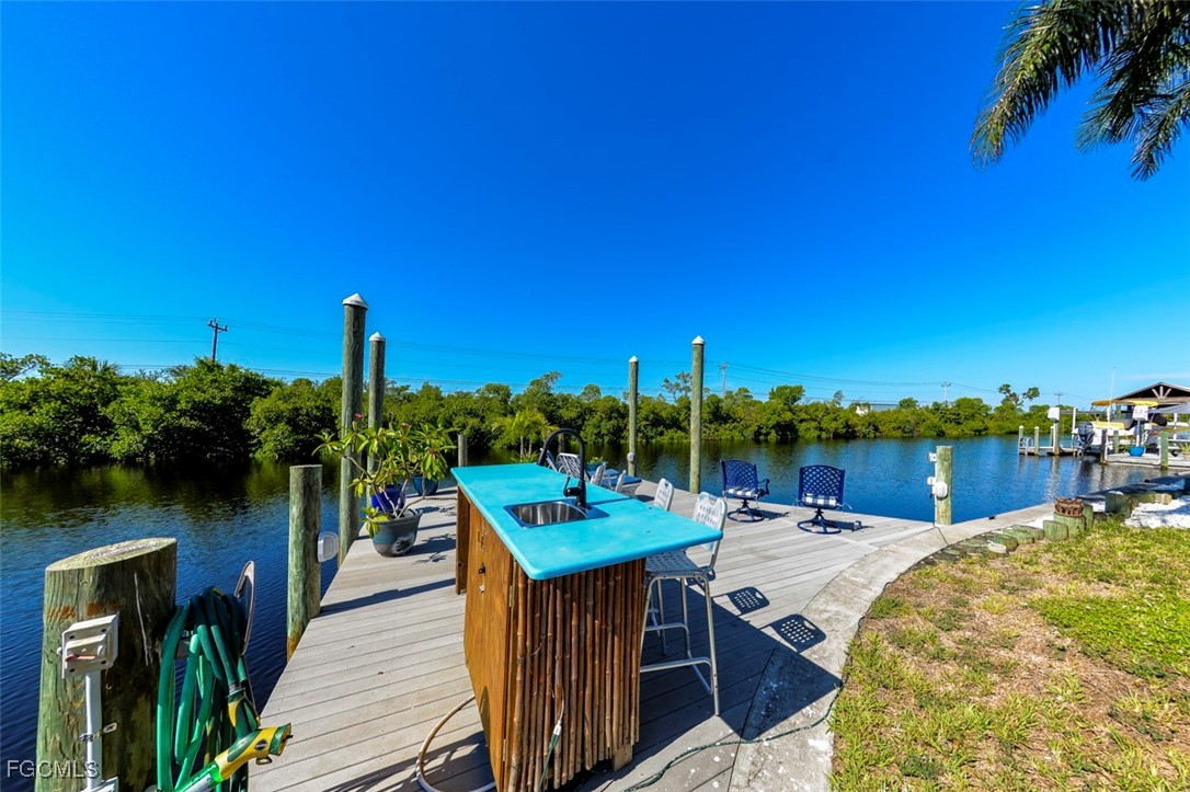 12082 Moon Shell Drive Matlacha Isles, FL 33991 - Photo 32 of 46 a view of a lake with couches of wooden floor and city view