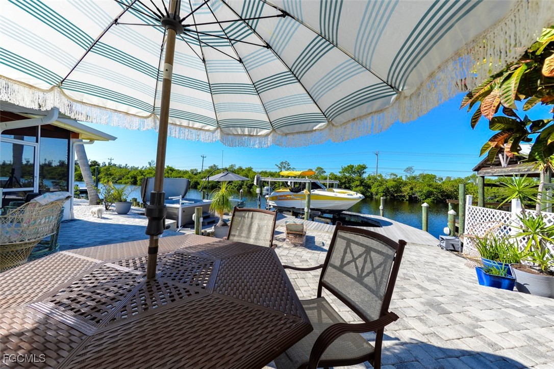 12082 Moon Shell Drive Matlacha Isles, FL 33991 - Photo 35 of 46 a view of a patio with swimming pool table and chairs