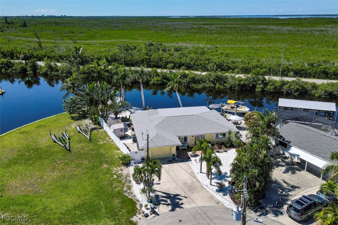 12082 Moon Shell Drive Matlacha Isles, FL 33991 - Photo 36 of 46 a view of a lake with a yard