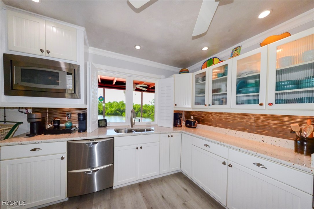 12082 Moon Shell Drive Matlacha Isles, FL 33991 - Photo 4 of 46 a kitchen with a sink stove and microwave