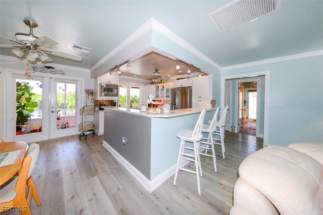 12082 Moon Shell Drive Matlacha Isles, FL 33991 - Photo 5 of 46 a living room with furniture and a wooden floor