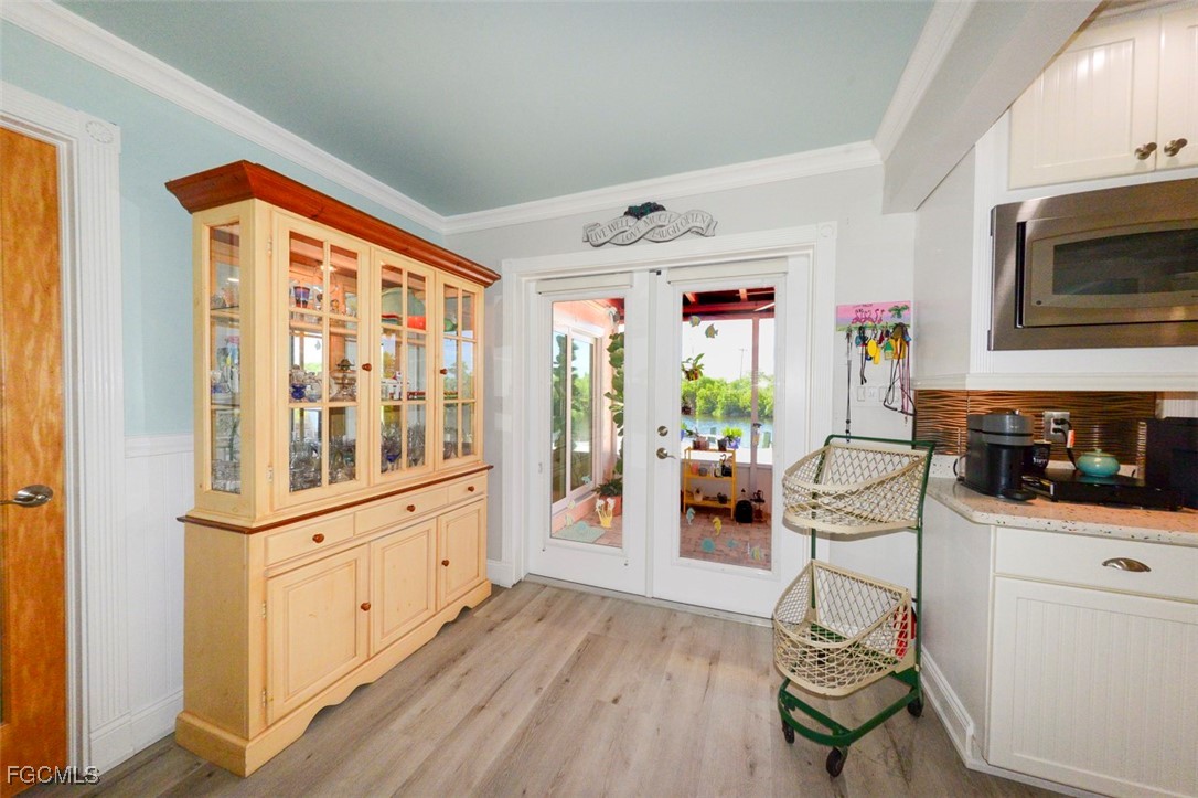 12082 Moon Shell Drive Matlacha Isles, FL 33991 - Photo 8 of 46 a hallway with furniture and wooden floor