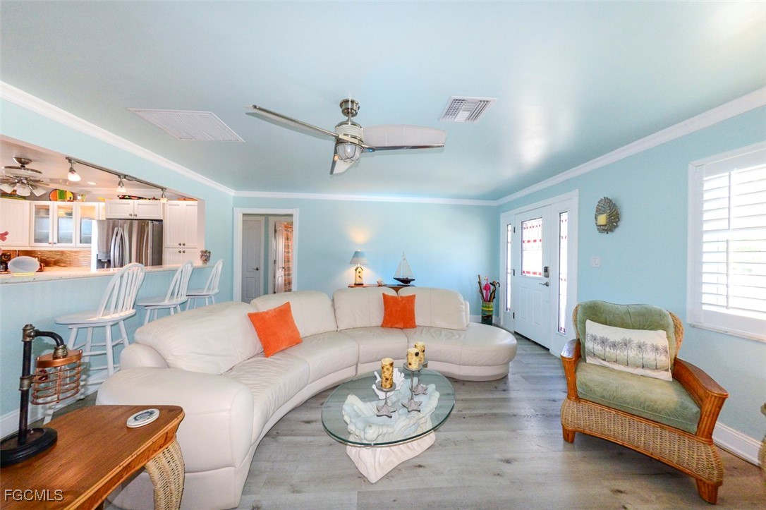 12082 Moon Shell Drive Matlacha Isles, FL 33991 - Photo 10 of 46 a living room with furniture and a wooden floor