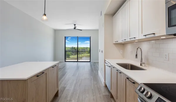 a kitchen with a sink a stove and cabinets