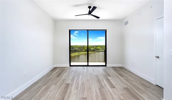 a view of an empty room with glass door