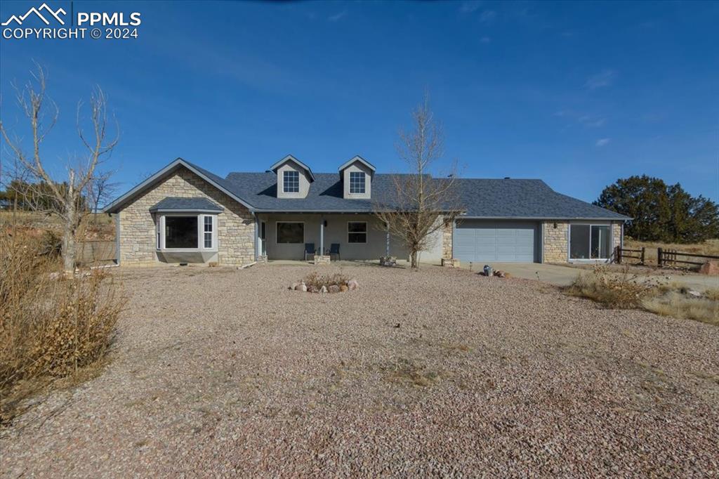 6670 Zercher Road Beulah, CO 81023 - Photo 13 of 37 a front view of a house with a yard and garage
