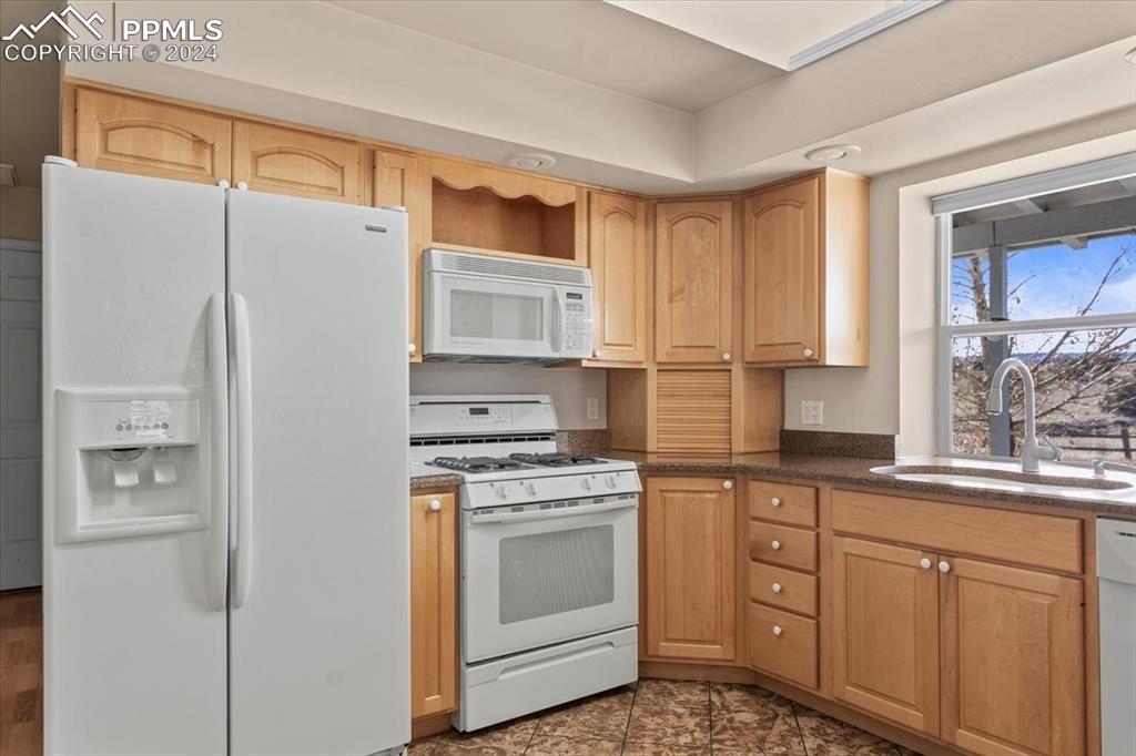 6670 Zercher Road Beulah, CO 81023 - Photo 22 of 37 a kitchen with white cabinets and white appliances