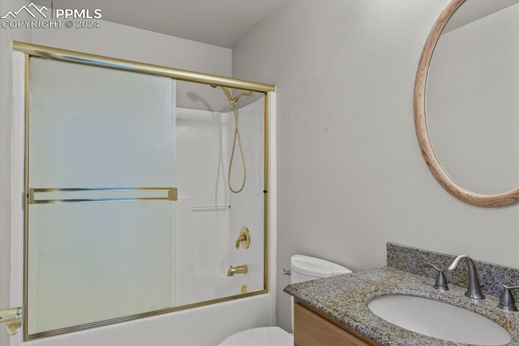 6670 Zercher Road Beulah, CO 81023 - Photo 23 of 37 a bathroom with a granite countertop shower sink vanity and a mirror