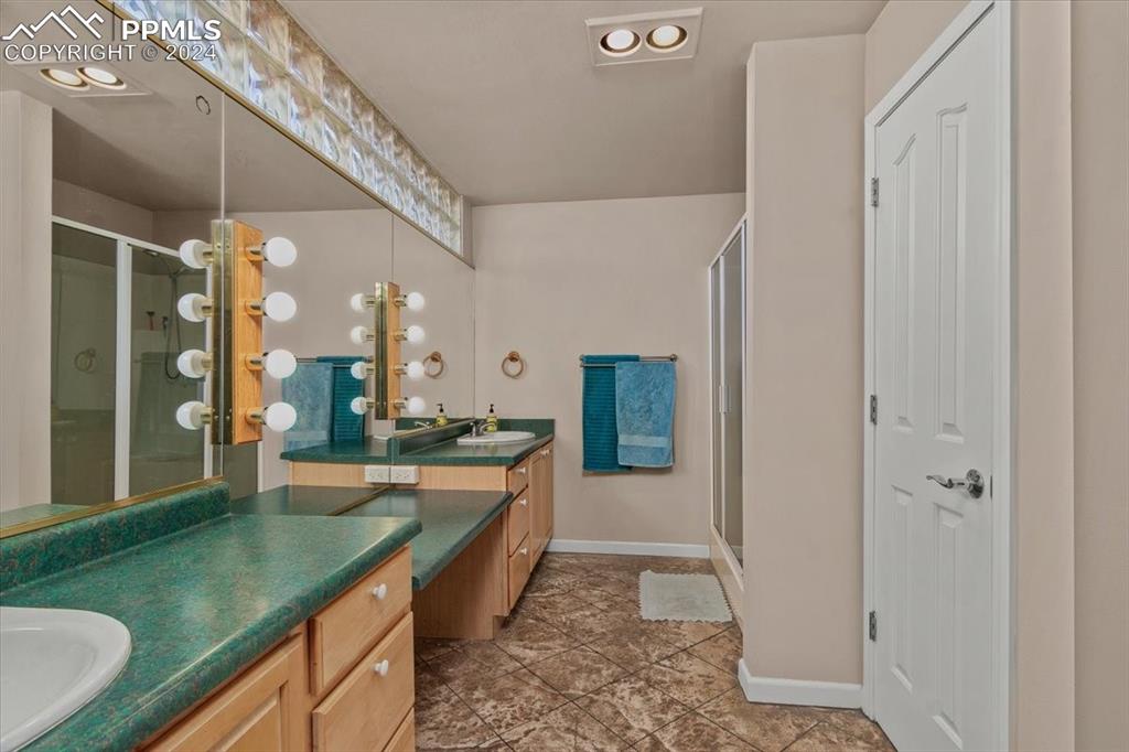 6670 Zercher Road Beulah, CO 81023 - Photo 29 of 37 a large bathroom with a granite countertop sink and a large mirror