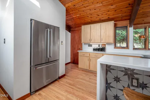 a kitchen with a refrigerator a sink and cabinets