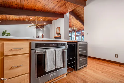 a view of a kitchen with wooden floor and a sink
