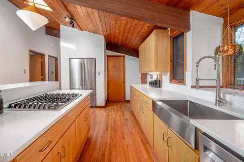 a kitchen with sink a stove and cabinets