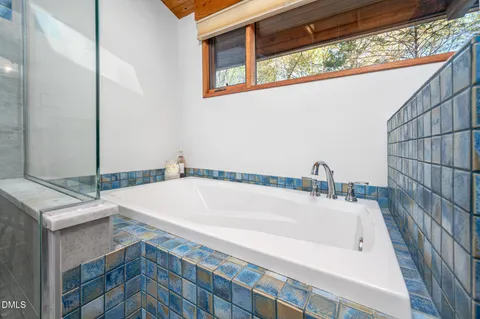 a bathroom with a bathtub and shower
