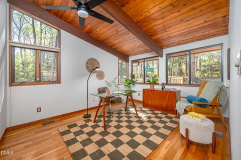 a living room with furniture a rug and a large window