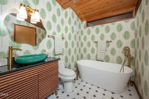 a white toilet sitting next to a white curtain