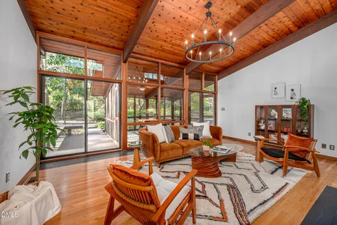 a living room with patio furniture and a large window