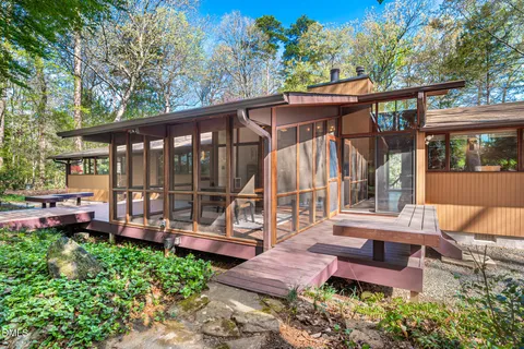 a view of a backyard with sitting area