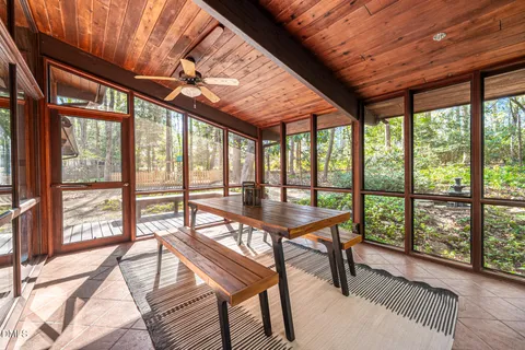 a view of a room with furniture and wooden floor