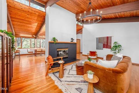 a outdoor space with patio the couches and a fireplace with wooden floor