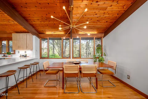 a dining room with furniture and wooden floor