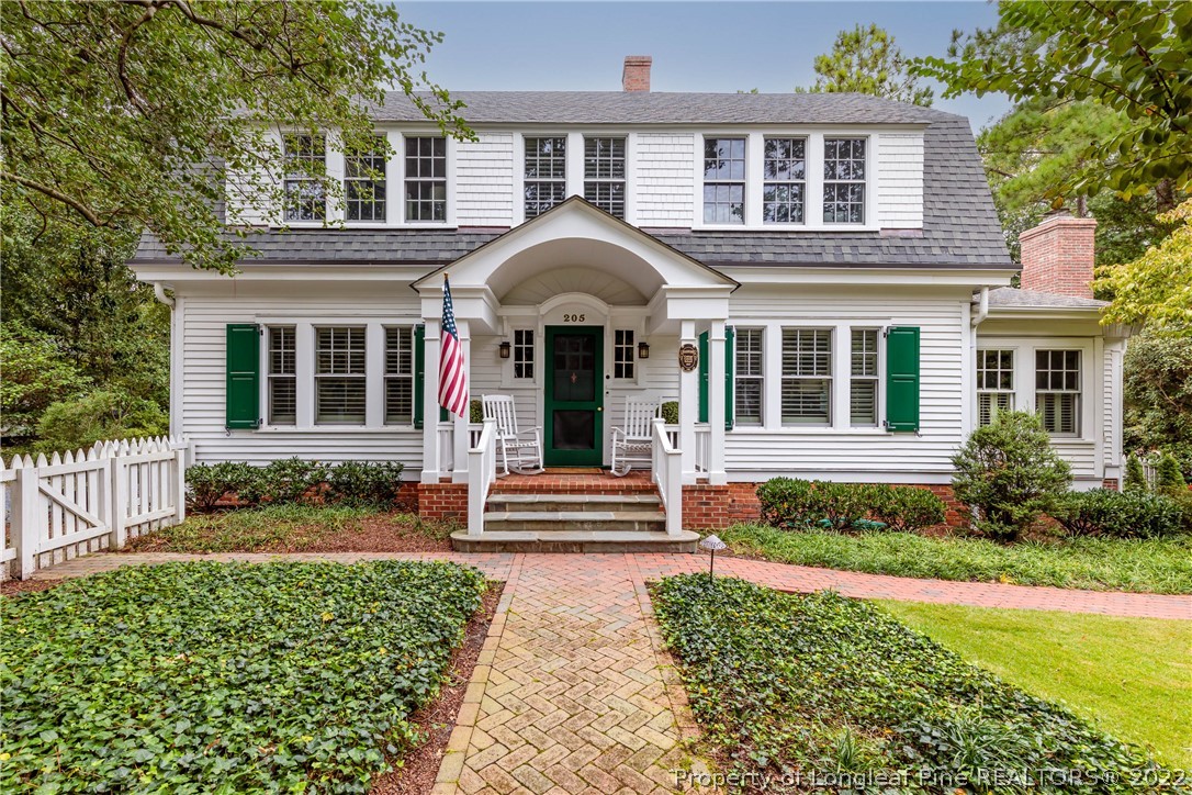 205 Cherokee Road Pinehurst, NC 28374 - Photo 1 of 39 a front view of a house with garden