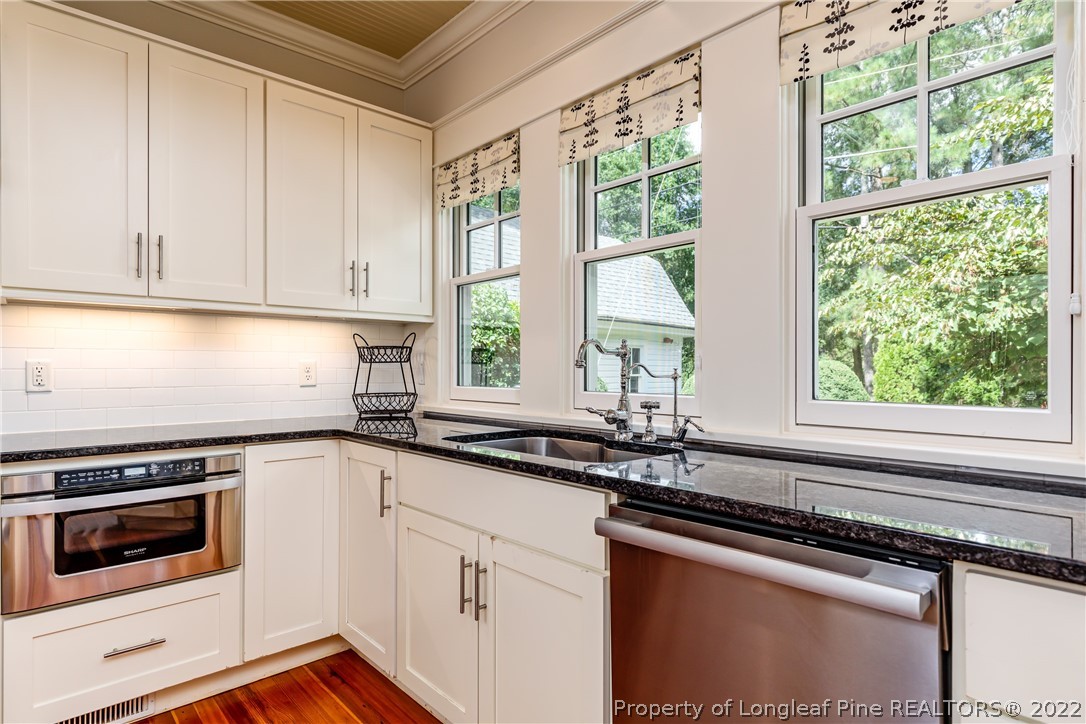 205 Cherokee Road Pinehurst, NC 28374 - Photo 12 of 39 a kitchen with a sink stove and cabinets