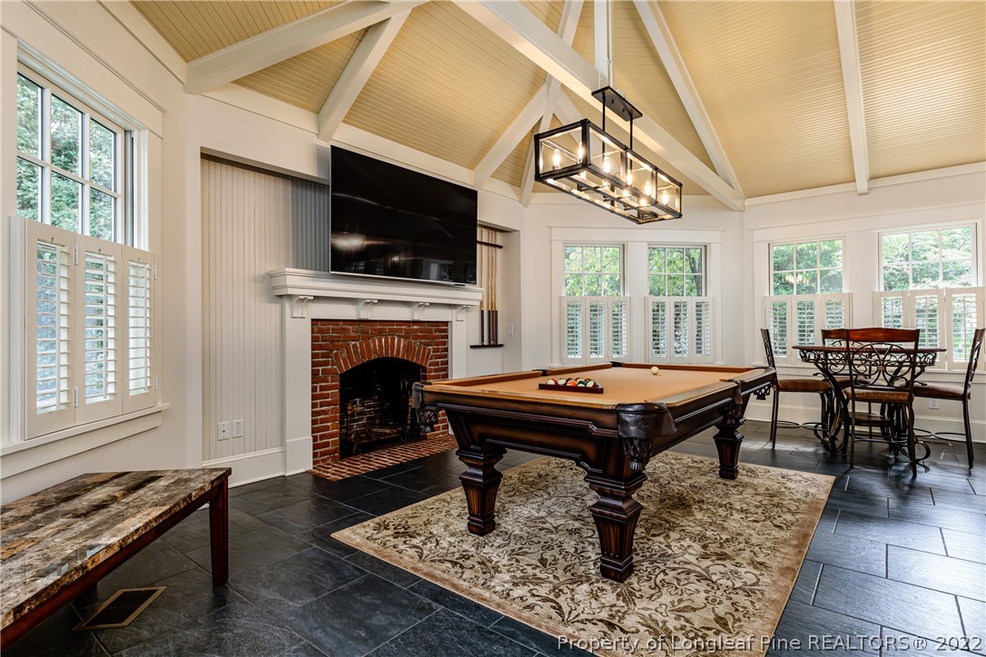 205 Cherokee Road Pinehurst, NC 28374 - Photo 16 of 39 a living room with a fireplace a flat screen tv and a fireplace