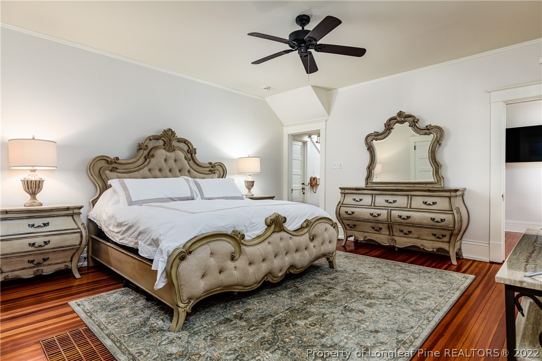 205 Cherokee Road Pinehurst, NC 28374 - Photo 24 of 39 a bedroom with a bed and wooden floor