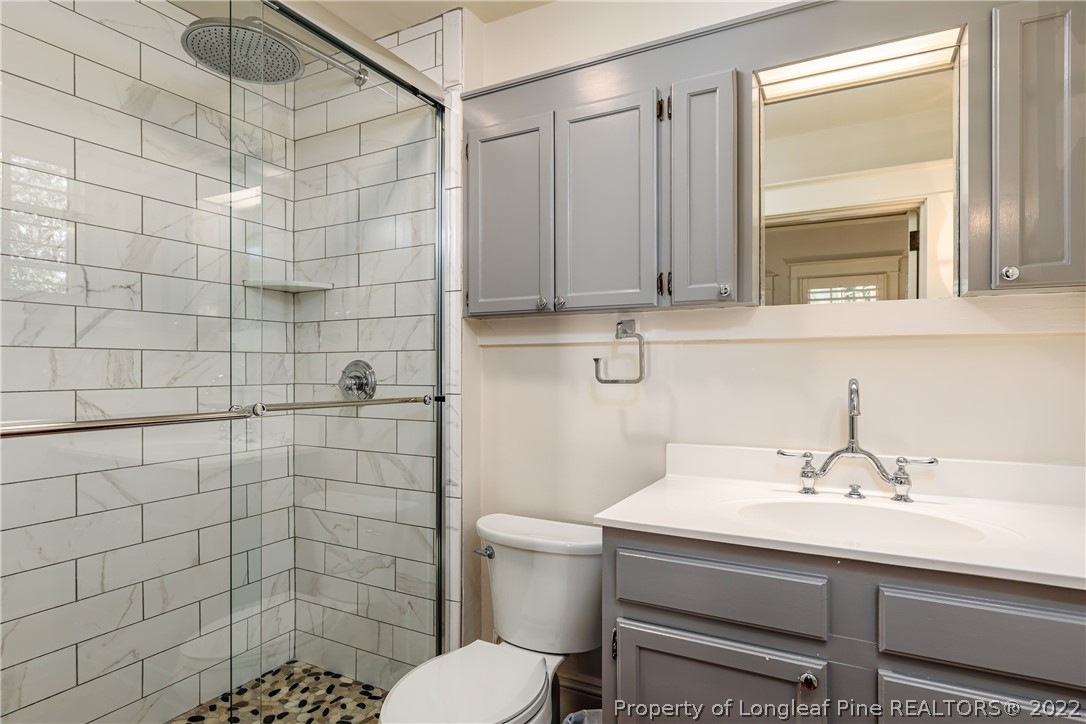 205 Cherokee Road Pinehurst, NC 28374 - Photo 27 of 39 a bathroom with a sink toilet and shower