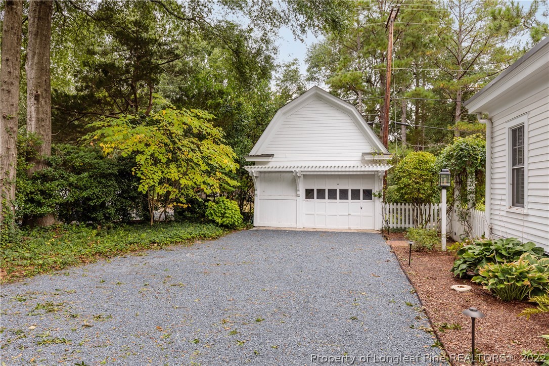205 Cherokee Road Pinehurst, NC 28374 - Photo 3 of 39 a view of a house with a yard and large trees