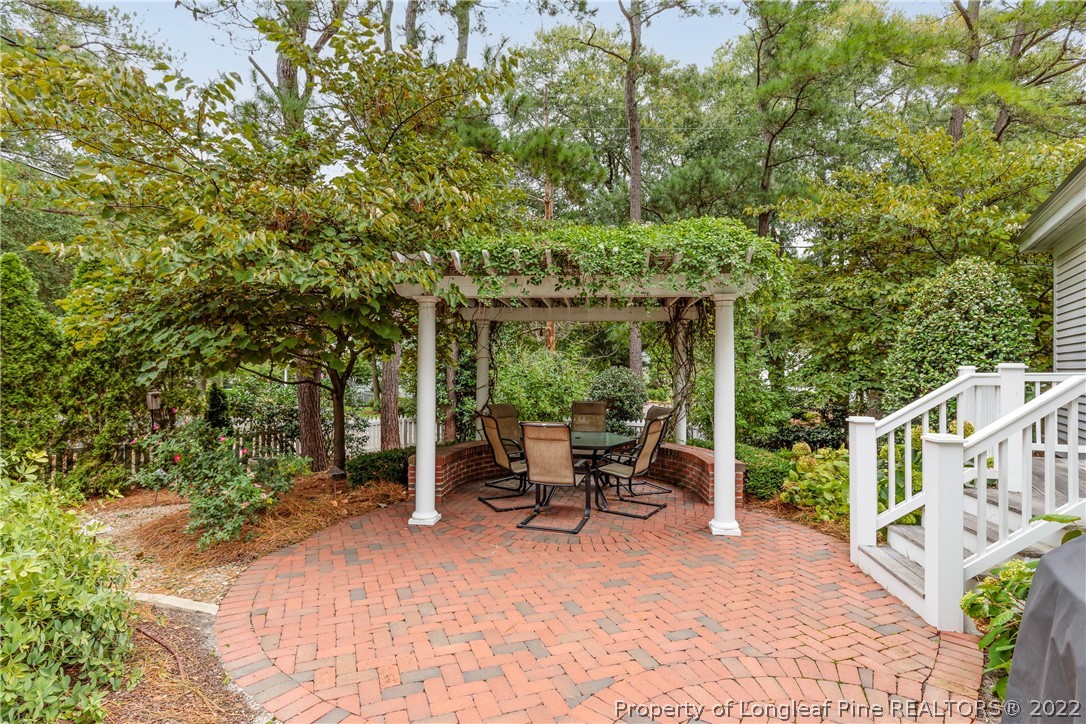 205 Cherokee Road Pinehurst, NC 28374 - Photo 5 of 39 a view of a patio with table and chairs and potted plants