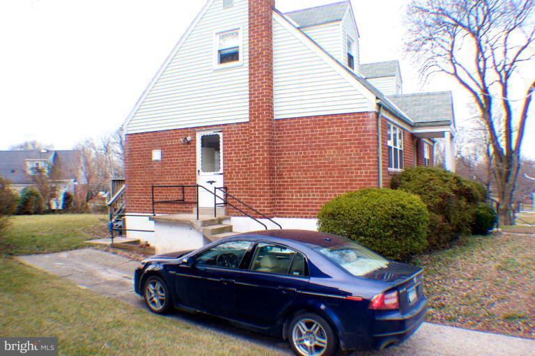 3710 Kayson Street Silver Spring, MD 20906 - Photo 18 of 24 a front view of a house with a garden and parking space