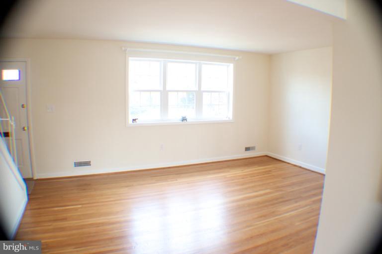 3710 Kayson Street Silver Spring, MD 20906 - Photo 20 of 24 an empty room with wooden floor and windows