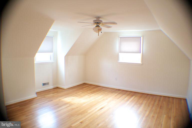 3710 Kayson Street Silver Spring, MD 20906 - Photo 21 of 24 an empty room with wooden floor fan and windows