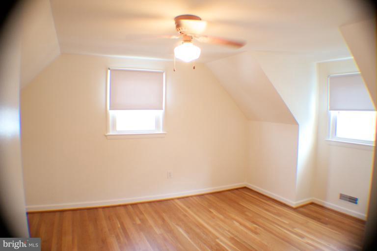3710 Kayson Street Silver Spring, MD 20906 - Photo 4 of 24 a view of an empty room with wooden floor and a window