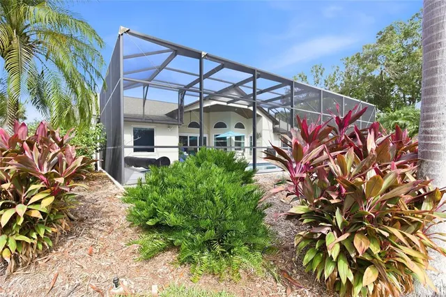 an aerial view of residential houses with outdoor space and swimming pool