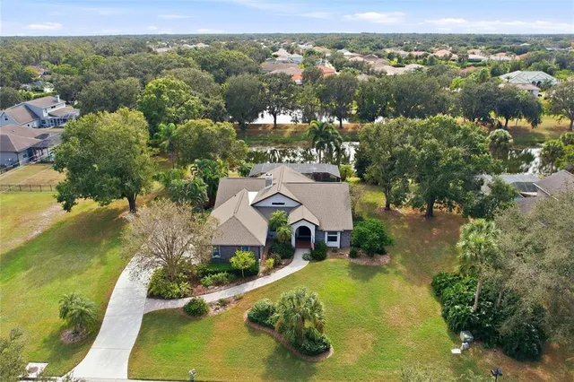 a aerial view of a house next to a yard