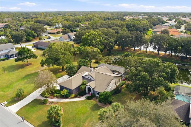 an aerial view of residential houses with outdoor space and swimming pool