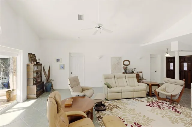 a living room with furniture and white walls