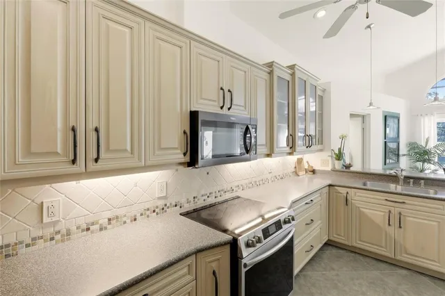 a kitchen with a sink stove and microwave