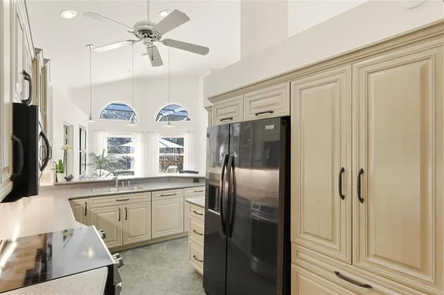 a kitchen with a refrigerator a sink and cabinets