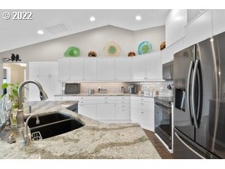 29682 View Street Rainier, OR 97048 - Photo 11 of 30 a kitchen with kitchen island granite countertop a sink stainless steel appliances and cabinets