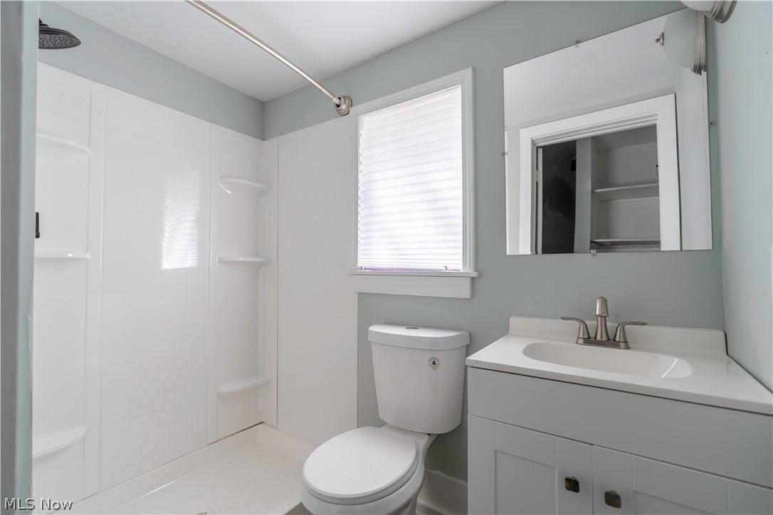 635 Mill Road Ravenna, OH 44266 - Photo 29 of 37 Bathroom with toilet, vanity with extensive cabinet space, walk in shower, and plenty of natural light