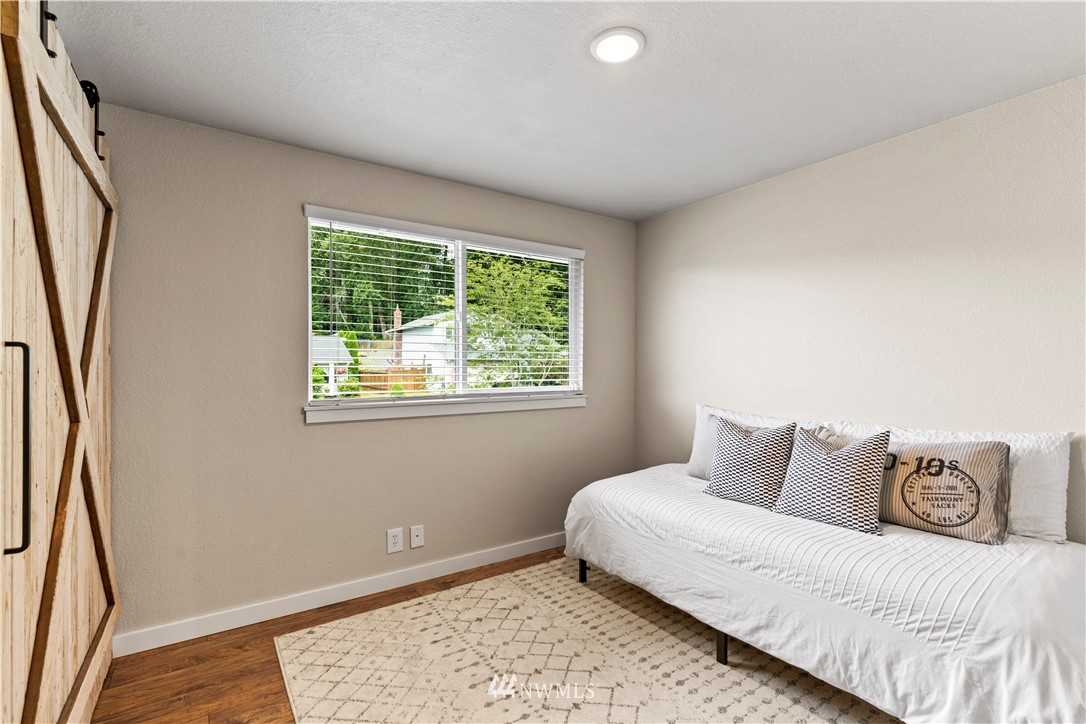 1128 235th Place Southwest Bothell, WA 98021 - Photo 11 of 22 a bedroom with a bed and wooden floor