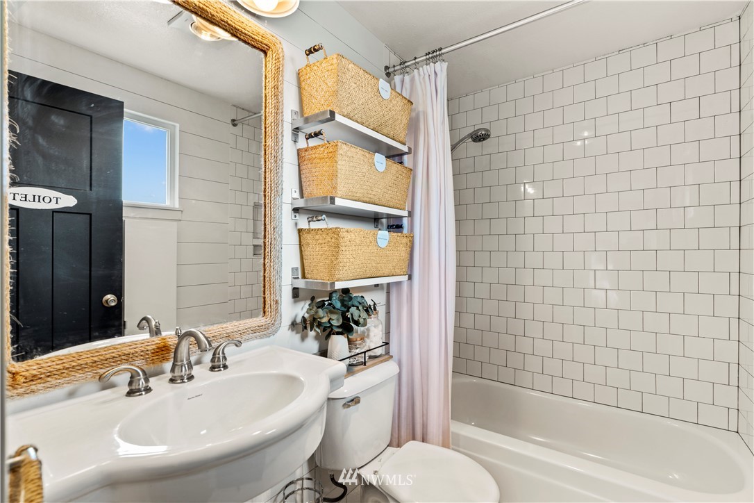 1128 235th Place Southwest Bothell, WA 98021 - Photo 15 of 22 a bathroom with a sink toilet and shower