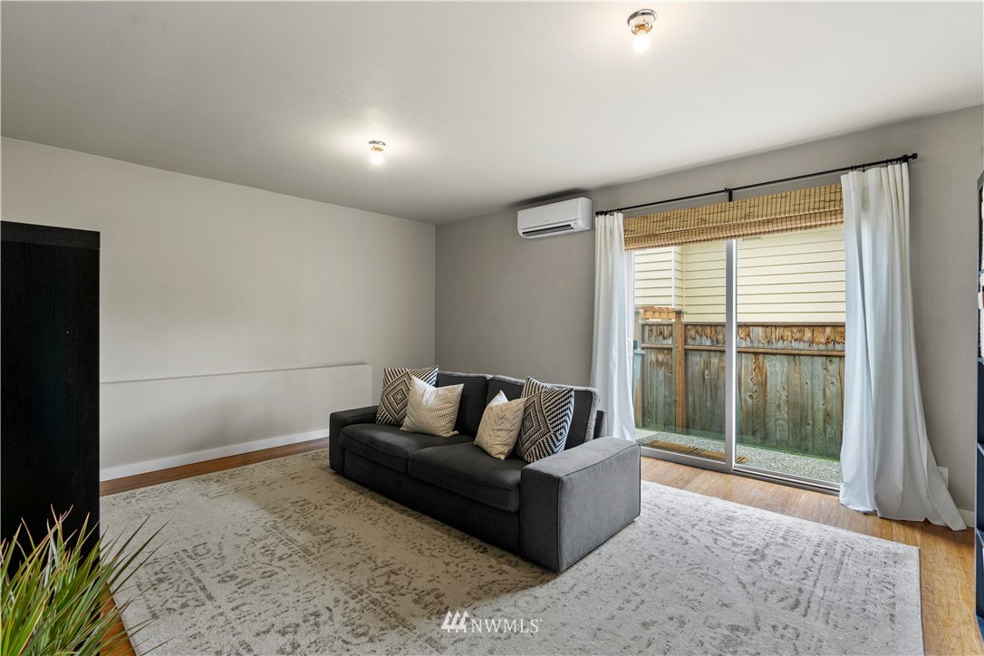 1128 235th Place Southwest Bothell, WA 98021 - Photo 17 of 22 a living room with furniture and a floor to ceiling window