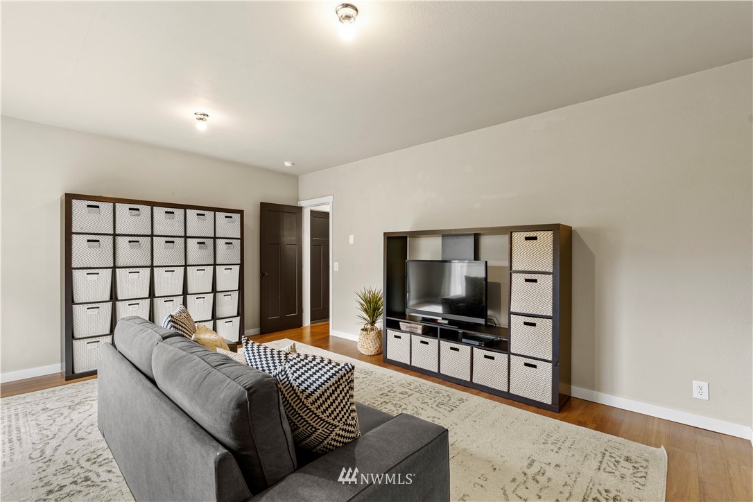 1128 235th Place Southwest Bothell, WA 98021 - Photo 18 of 22 a living room with furniture and a flat screen tv