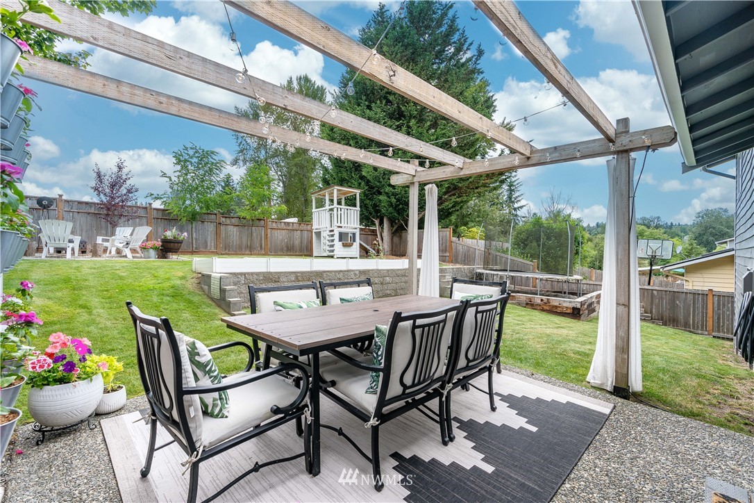 1128 235th Place Southwest Bothell, WA 98021 - Photo 19 of 22 a table and chairs in front of a building