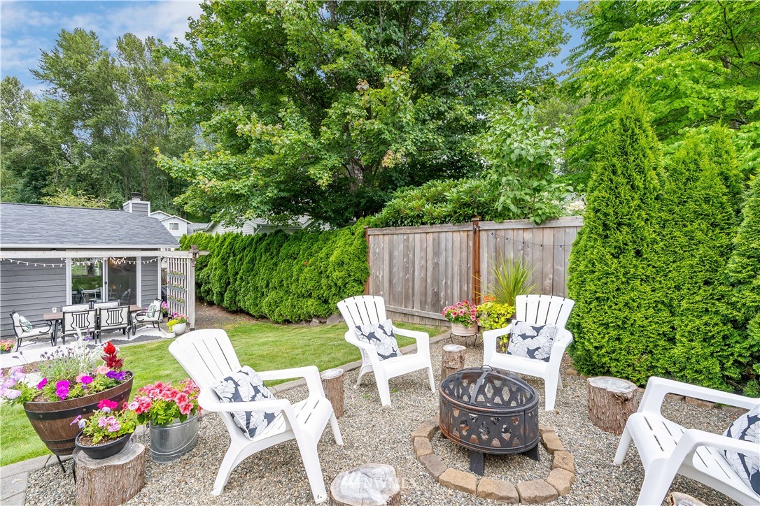 1128 235th Place Southwest Bothell, WA 98021 - Photo 20 of 22 a view of a chairs and table in backyard of the house