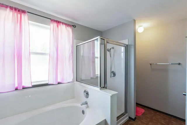 a bathroom with a bathtub and a shower